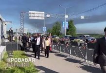 Participants of the economic forum in St. Petersburg against the backdrop of a burning oil refinery