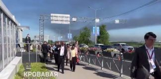 Participants of the economic forum in St. Petersburg against the backdrop of a burning oil refinery