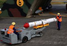 Taiwanese servicemen transport a US AGM-84L Harpoon anti-ship missile near an aircraft hangar