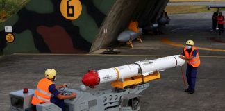 Taiwanese servicemen transport a US AGM-84L Harpoon anti-ship missile near an aircraft hangar