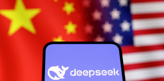 The US is holding back on sanctions against DeepSeek: over 100 Chinese companies face being blacklisted The DeepSeek logo on a smartphone screen, set against a backdrop of the Chinese and US flags