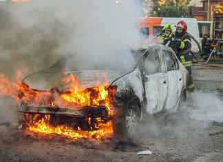 Russian UAV attack in Sumy: a burnt-out car in a car park.