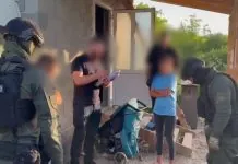 Правоохоронці вилучають докази під час обшуку у справі про трансляції порнографії з неповнолітньою на Закарпатті.