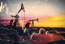 Oil rigs set against a backdrop of graphs showing falling oil prices, symbolising the decline in prices on the global energy market.
