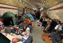 People in the Kyiv metro during the air raid with things for a long stay in the shelter.