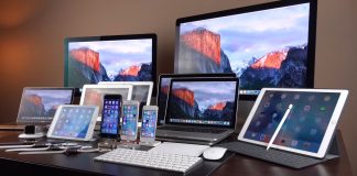 Apple’s range of devices, including the iPhone, iPad, MacBook, iMac and other Apple products, all displayed on a single desk.