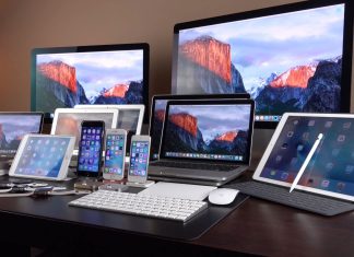 Лінійка пристроїв Apple, включно з iPhone, iPad, MacBook, iMac та іншою технікою компанії, представленою на одному робочому столі.