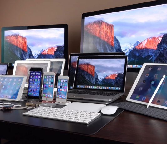 Лінійка пристроїв Apple, включно з iPhone, iPad, MacBook, iMac та іншою технікою компанії, представленою на одному робочому столі.