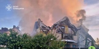 Firefighters extinguish a fire after rocket attacks in a residential area of Kyiv region.
