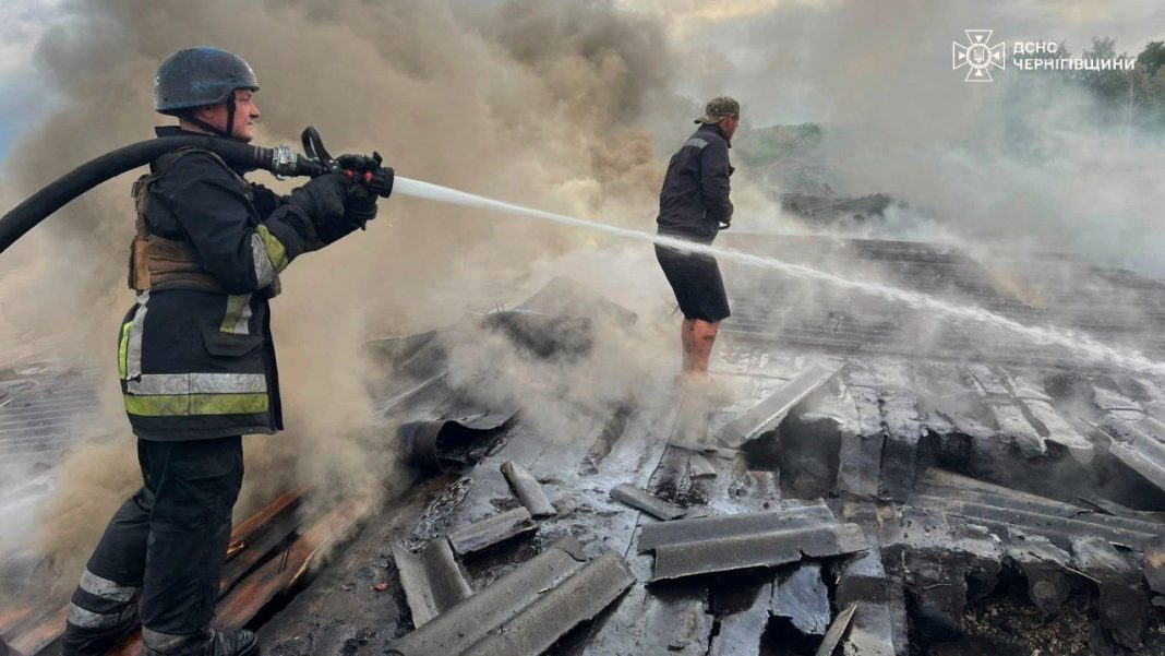 Firefighters extinguish a fire in a warehouse building after a drone attack in Chernihiv region.
