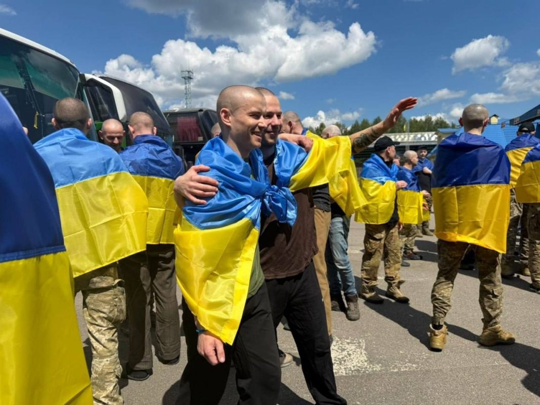 The liberated Ukrainian defenders return to their homeland surrounded by support and flags.