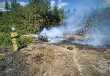 Rescue workers at the scene of a fire in the Kyiv region following an enemy attack.