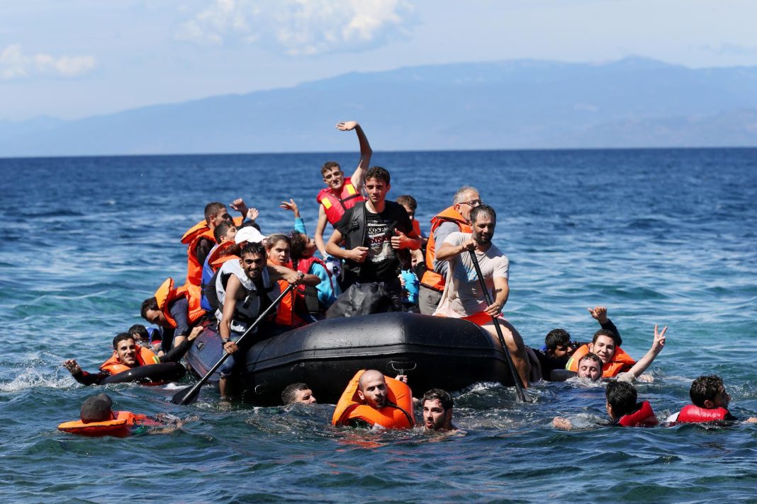 refugee-crisis-EU-1 A group of refugees on an inflatable boat off the coast of Spain