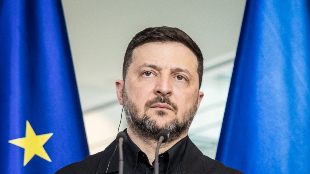 The President of Ukraine, Volodymyr Zelenskyy, against a backdrop of a map of Crimea.