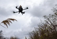 A soldier is operating a drone