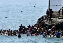Migrants reach the coast of the Spanish enclave of Ceuta by swimming