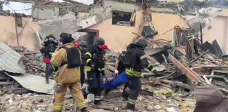 Rescue workers among the rubble following a Russian cruise missile strike on Zaporizhzhia