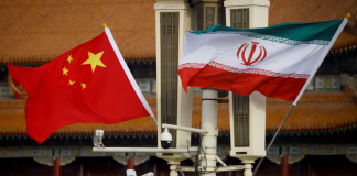 The flags of China and Iran against a backdrop of reports of MANPADS purchases