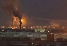 The Saratov oil refinery following an attack by Ukrainian drones; thick smoke hangs over the plant.