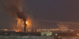 The Saratov oil refinery following an attack by Ukrainian drones; thick smoke hangs over the plant.