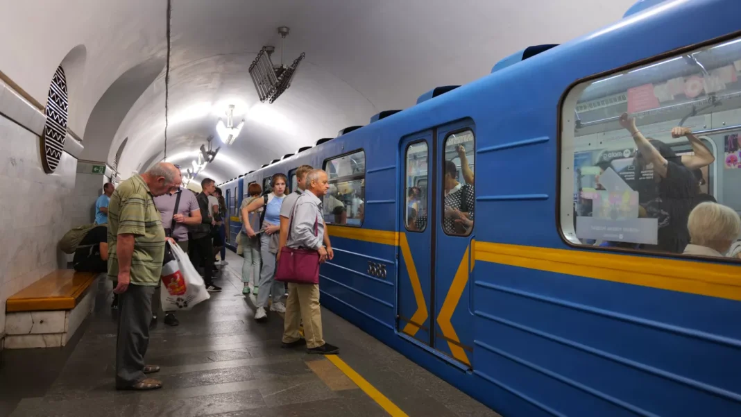 Metro carriage Passengers on the platform of a Kyiv Metro underground station are waiting by a blue carriage