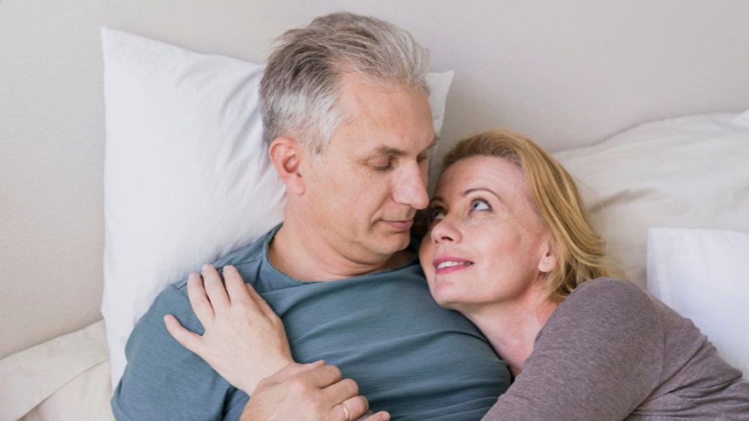 50_1200x675 A couple in their 50s are relaxing together in bed