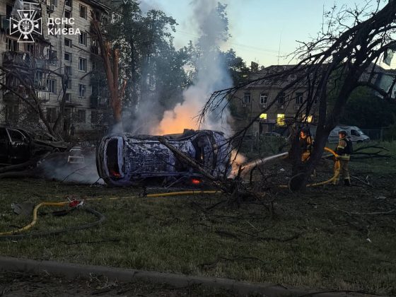 A burning car near residential buildings following a Russian missile strike on Kyiv.