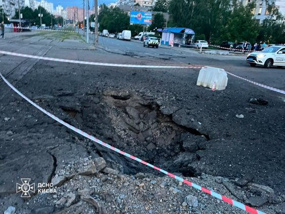 A crater on the carriageway following a Russian strike on the Darnytskyi district of Kyiv.