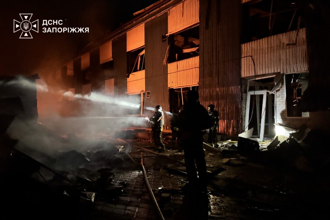 Emergency services are putting out a fire at a damaged retail premises in Zaporizhzhia