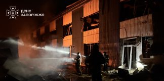 Emergency services are putting out a fire at a damaged retail premises in Zaporizhzhia