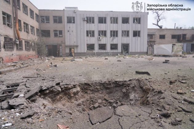 A crater and damaged buildings following an air strike on Zaporizhzhia