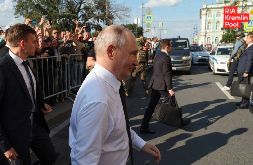 Putin chats with people on the street during his visit to St Petersburg