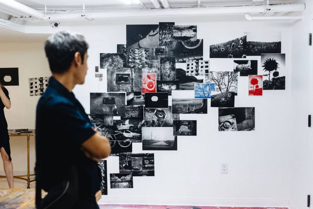 A visitor looks at photographs by Giles Duley at the exhibition