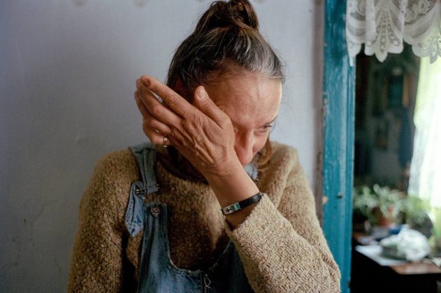 A woman is crying in her home during the war in Ukraine