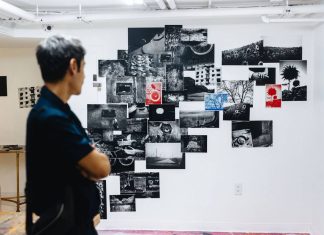 A visitor looks at photographs by Giles Duley at the exhibition
