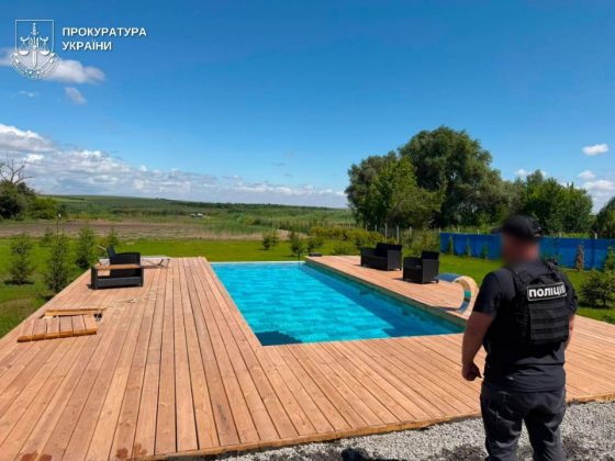 A swimming pool at a private residence being inspected by law enforcement officers in the Odesa region