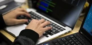 A screen displaying code and an artificial intelligence symbol, illustrating cybersecurity