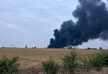 Thick black smoke rises above the scene of a fire at a warehouse in the Mykolaiv district following a Russian attack