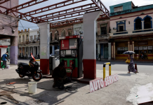 Fuel canisters next to a car in Cuba