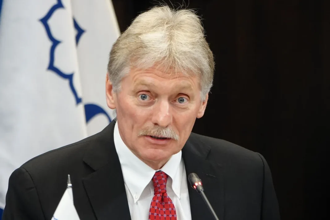 photo_2025_11_13_12_42_44 A man in a suit is speaking into a microphone during an official event