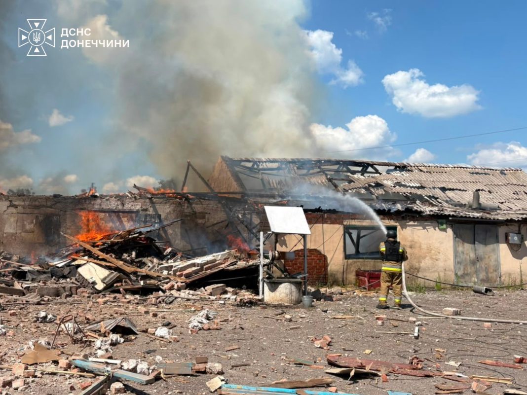 Rescue workers are putting out a fire following a Russian strike in the Donetsk region
