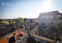 Rescue workers are putting out a fire following a drone attack in Bilhorod-Dnistrovskyi