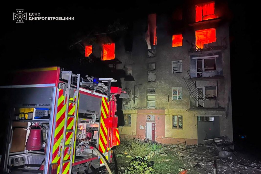 Rescue workers are at the scene of a residential building in Marganets that was damaged by a Russian drone