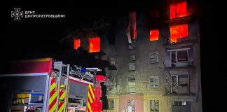 Rescue workers are at the scene of a residential building in Marganets that was damaged by a Russian drone
