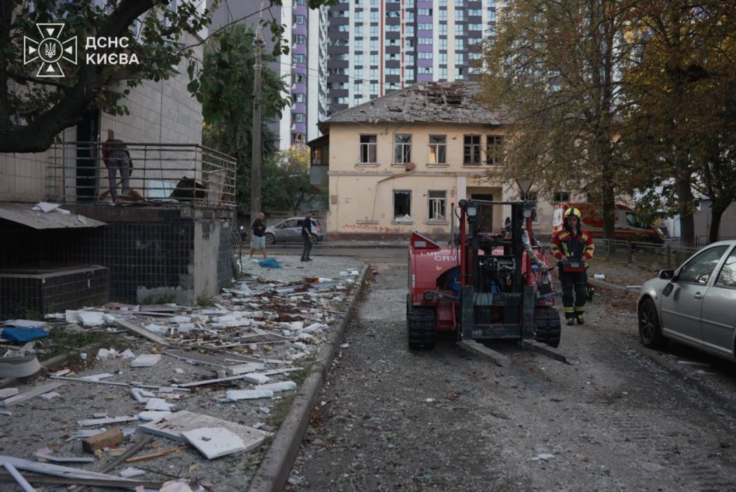 Rescue workers are at the scene of a damaged building in Kyiv following a Russian attack