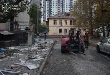 Rescue workers are at the scene of a damaged building in Kyiv following a Russian attack