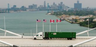 The US has imposed 50% tariffs on certain goods from Canada The US and Canadian flags against the backdrop of a trade dispute
