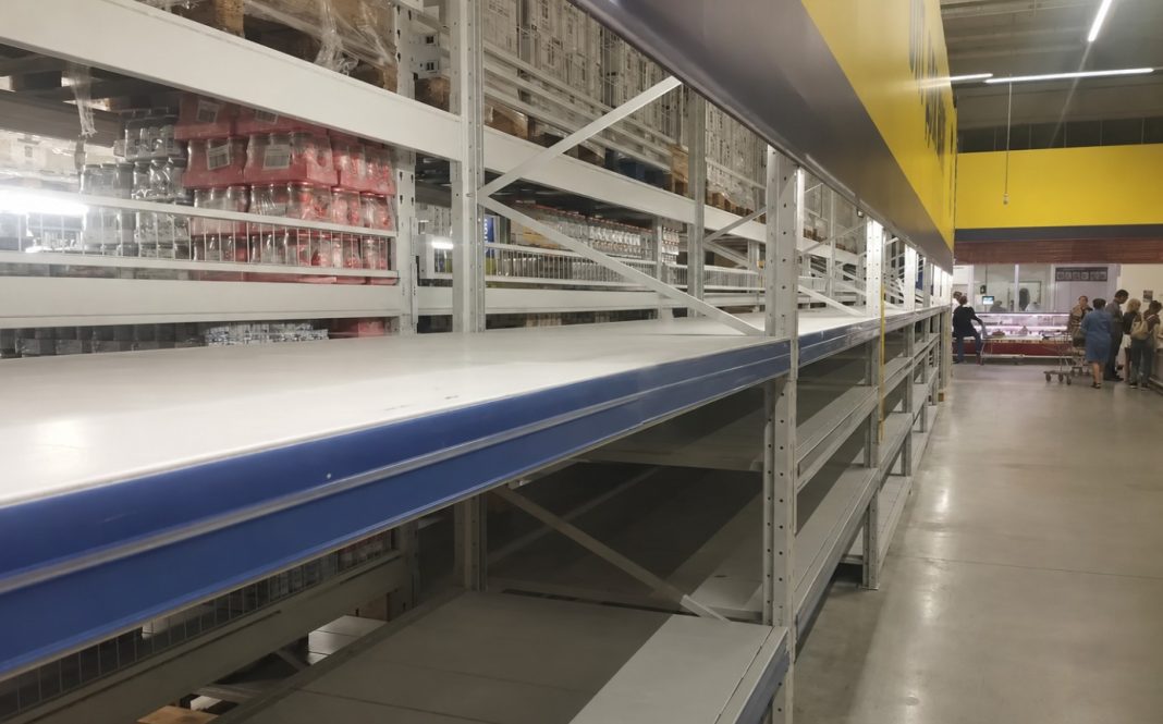 Empty shelves in the supermarket due to disruptions to food supplies