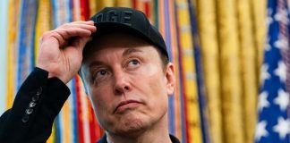 Elon Musk against the backdrop of the American flag