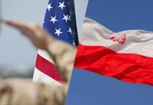 The US is to establish a permanent military base in Poland The flags of the USA and Poland against the backdrop of an American soldier